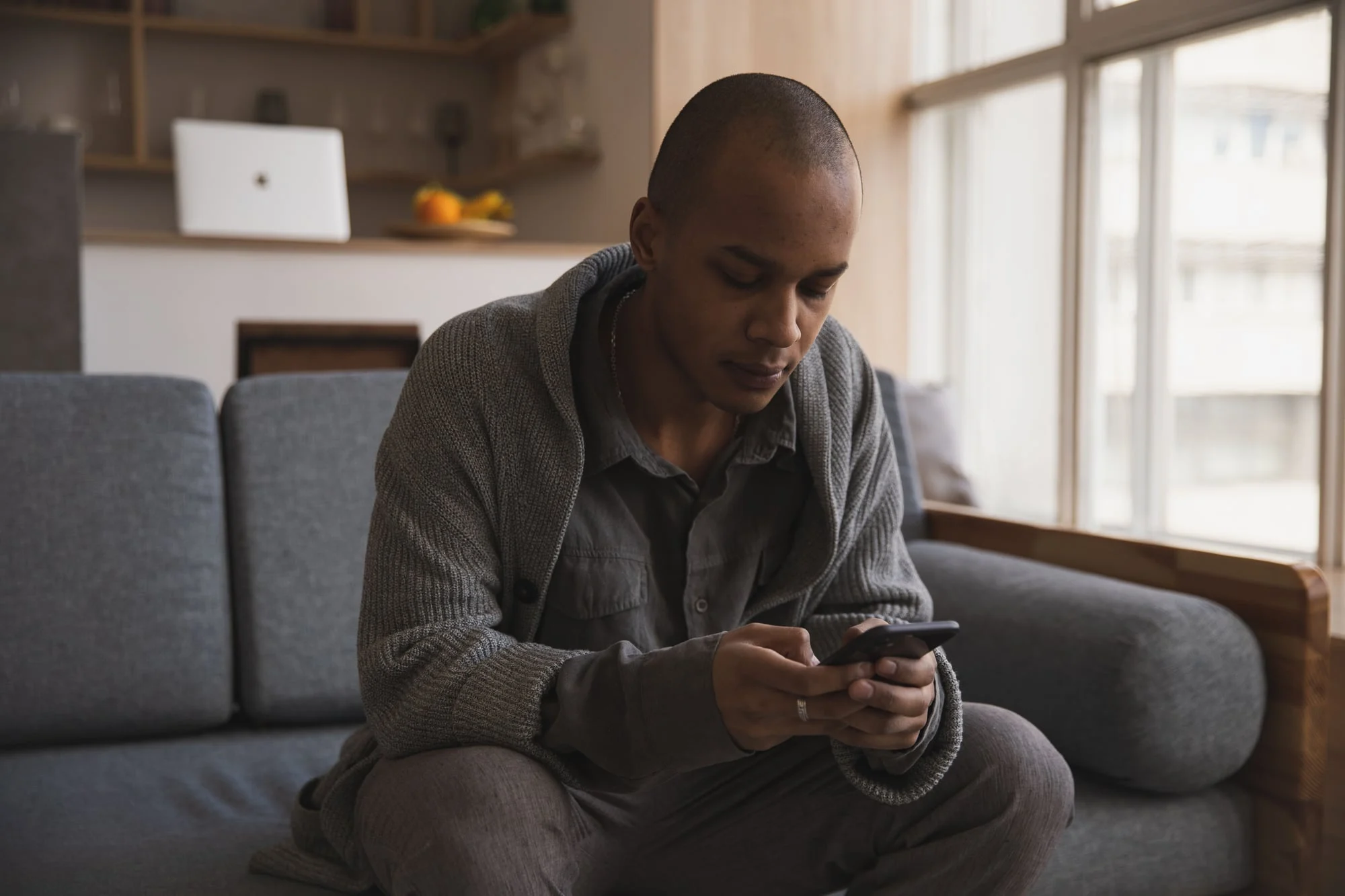 Man looking at a website on his phone at home.