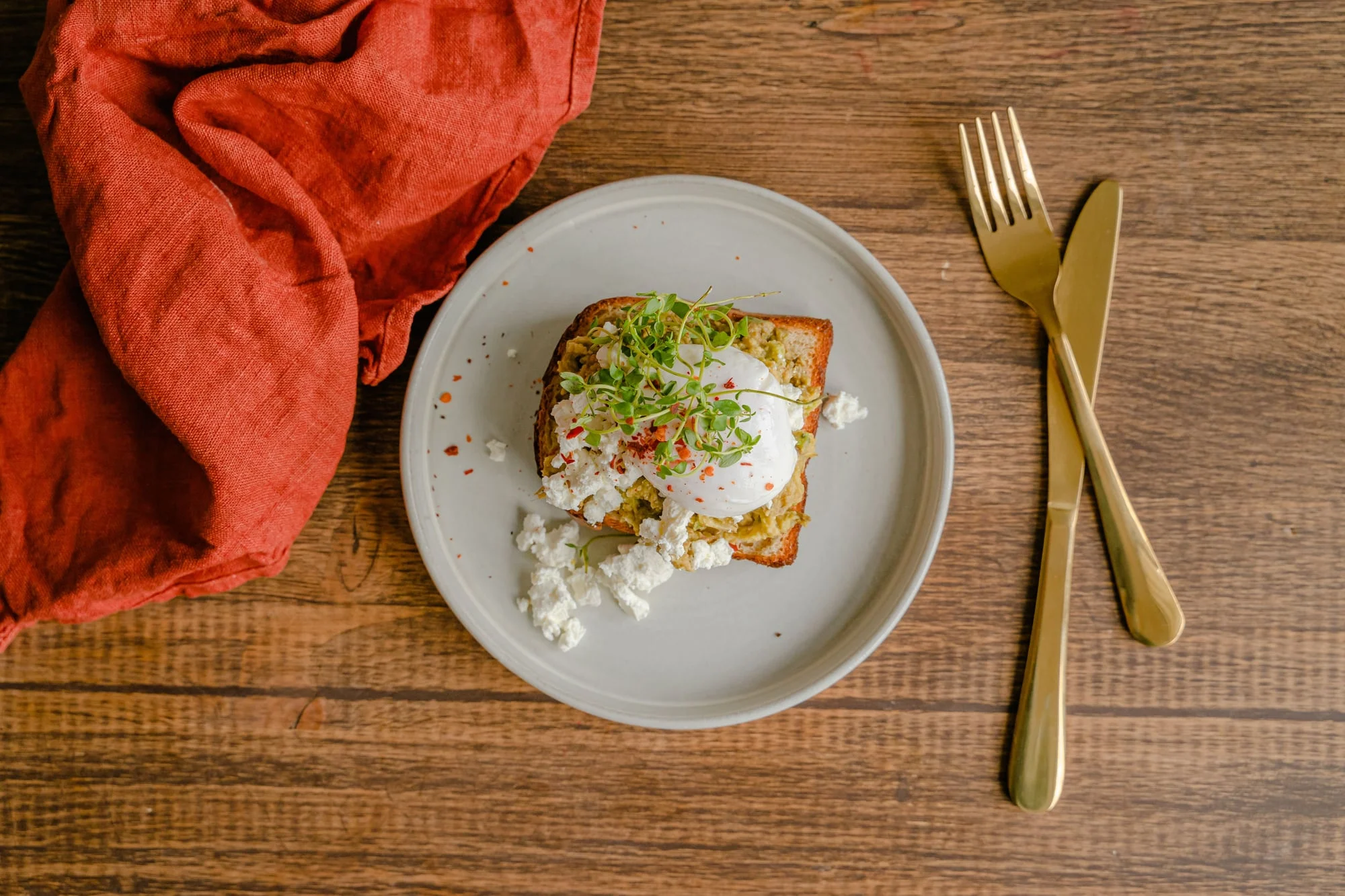 A small plate of food on a wooden table.